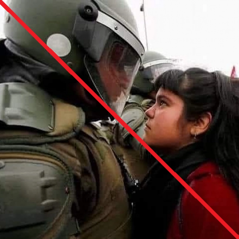False: This image shows a Palestinian girl having a staredown with a soldier.