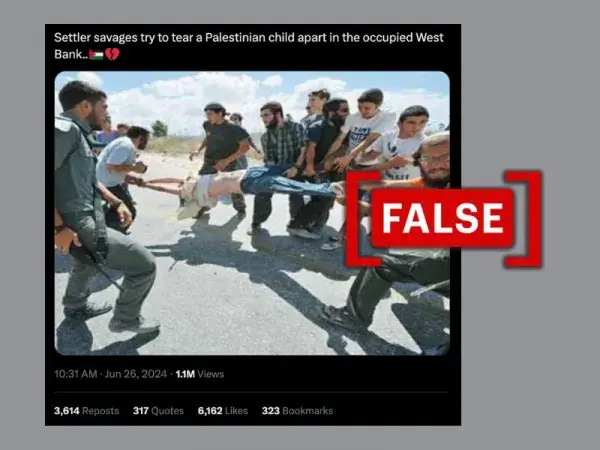 No, this photo doesn't show Israeli settlers trying to harm a Palestinian child