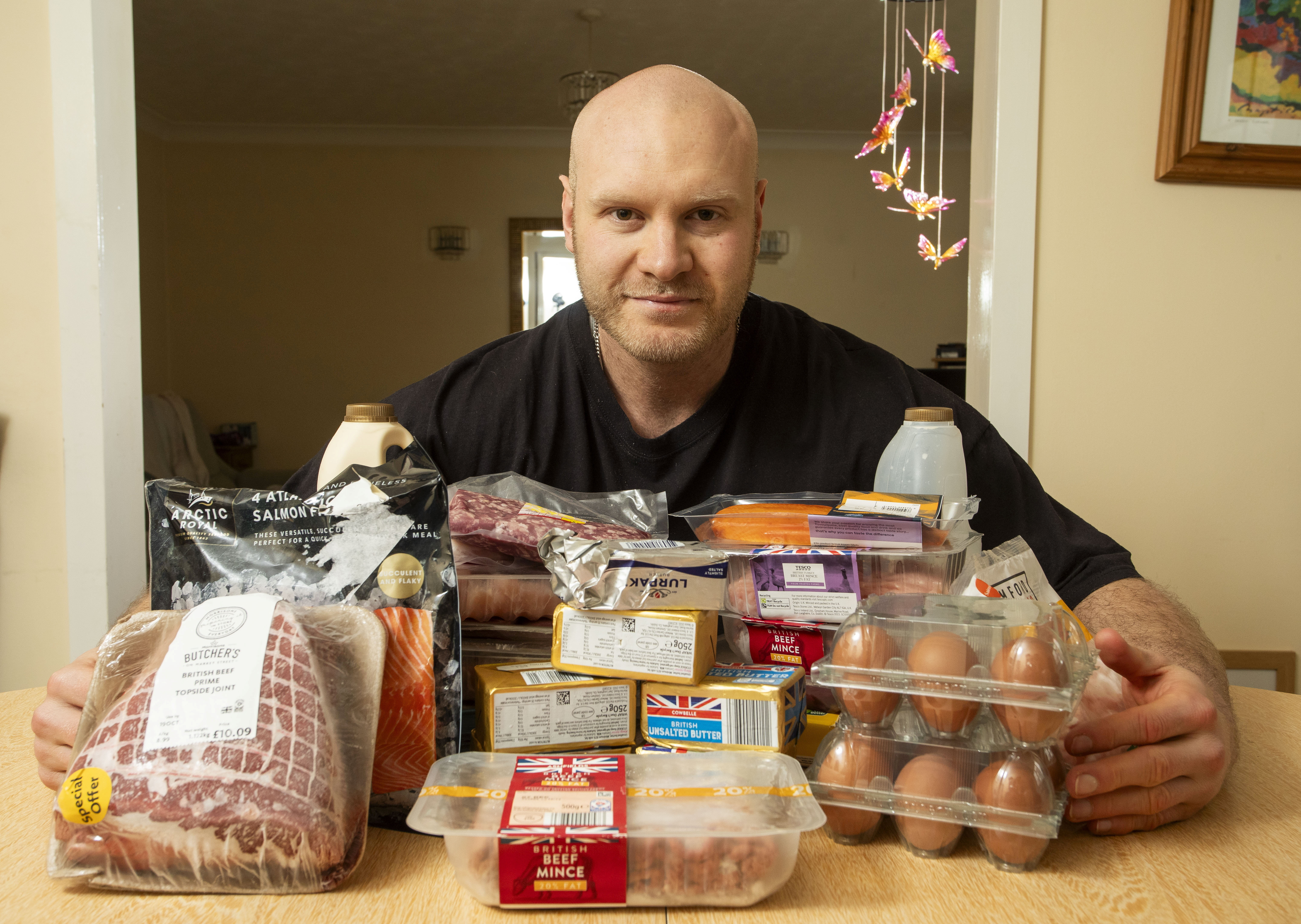 Bodybuilder Jonathon Griffiths, who has been eating a completely animal-based diet for the last four years, poses with various meats, eggs and butter.